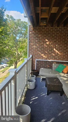 a view of a patio with chairs and potted plants
