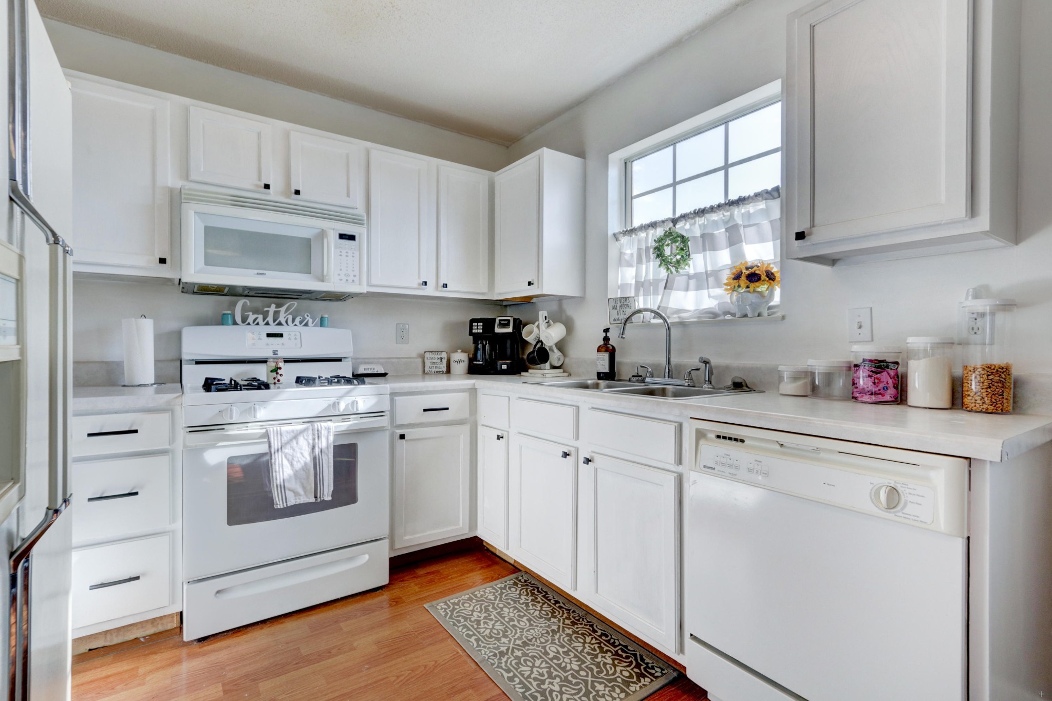 7832 Ralph Youmans Road Corryton, TN 37721 - Photo 12 of 22 a kitchen with granite countertop white cabinets and white appliances
