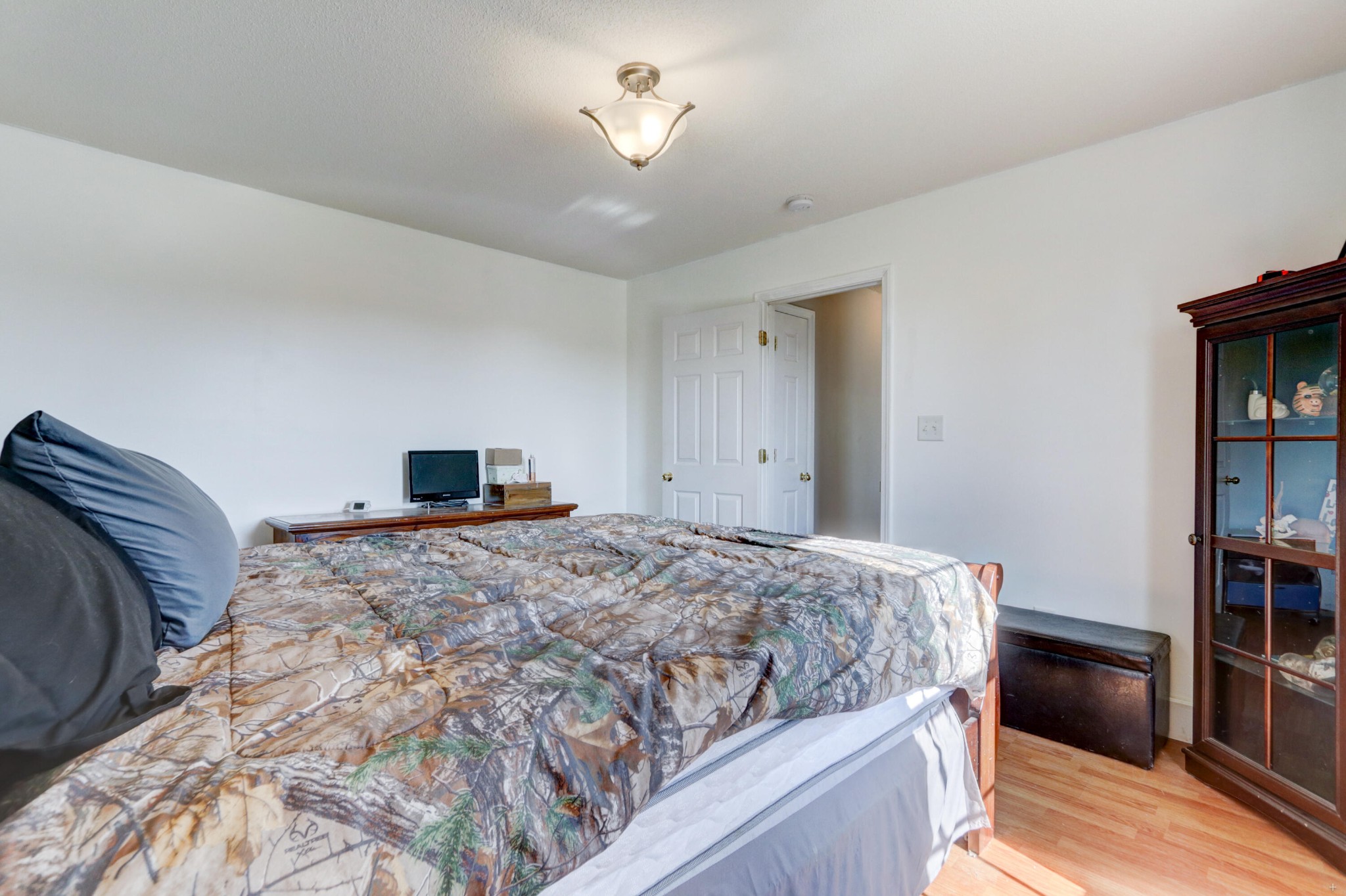 7832 Ralph Youmans Road Corryton, TN 37721 - Photo 17 of 22 a bedroom with a bed and a bookshelf