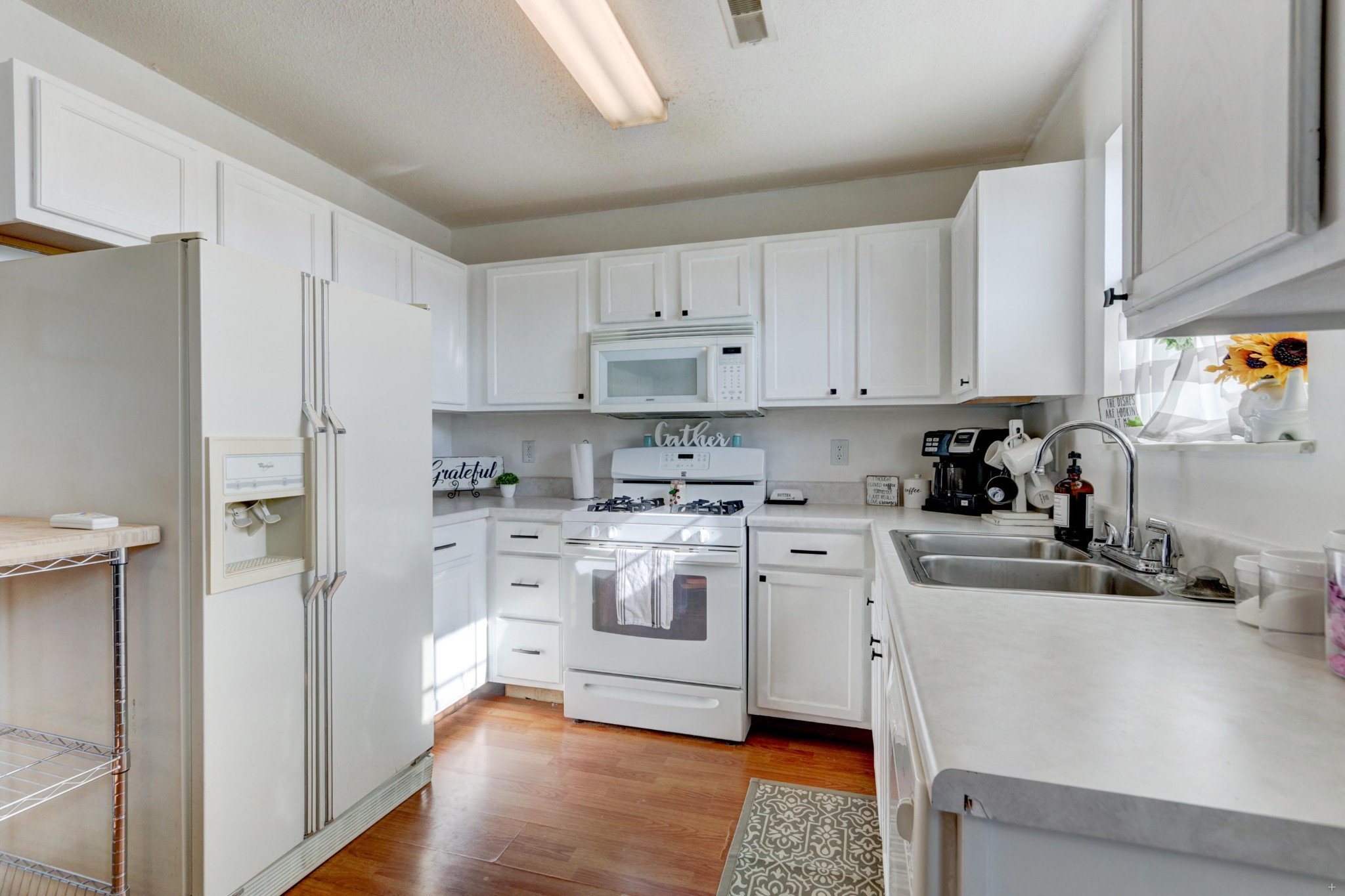7832 Ralph Youmans Road Corryton, TN 37721 - Photo 21 of 22 a kitchen with white cabinets and white appliances