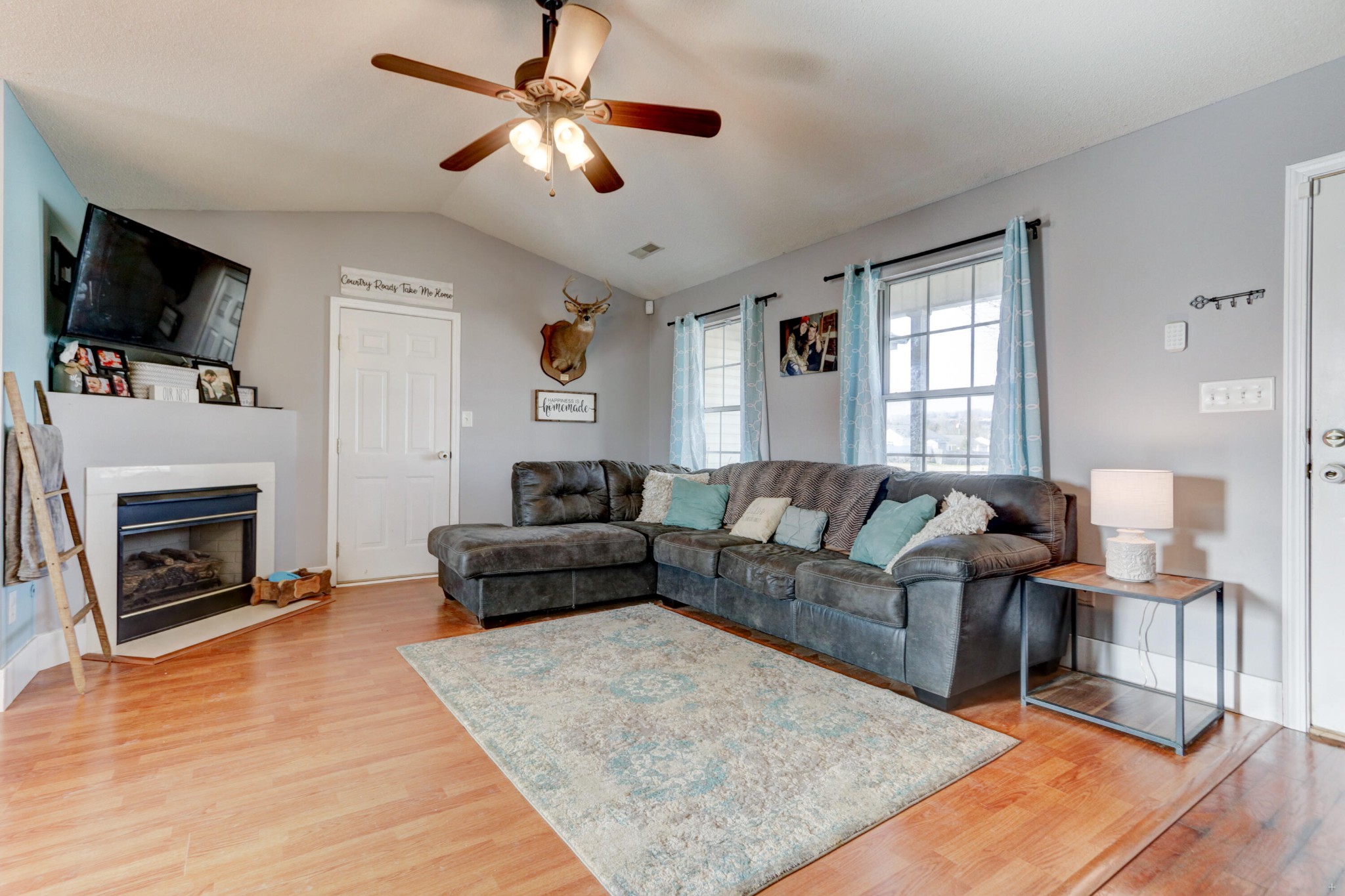 7832 Ralph Youmans Road Corryton, TN 37721 - Photo 3 of 22 a living room with furniture a flat screen tv and a fireplace