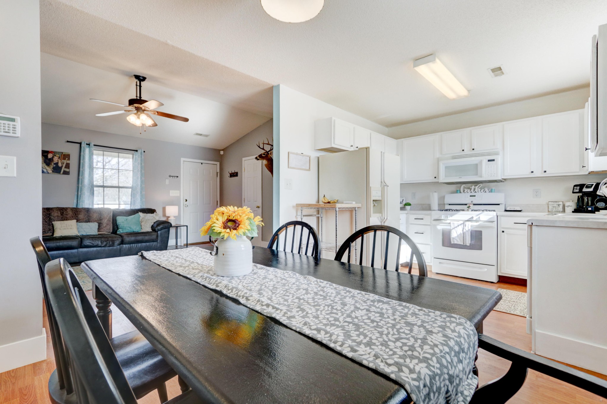 7832 Ralph Youmans Road Corryton, TN 37721 - Photo 10 of 22 a kitchen with stainless steel appliances granite countertop a dining table chairs sink refrigerator and microwave