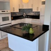 a kitchen with stainless steel appliances granite countertop a sink and a stove