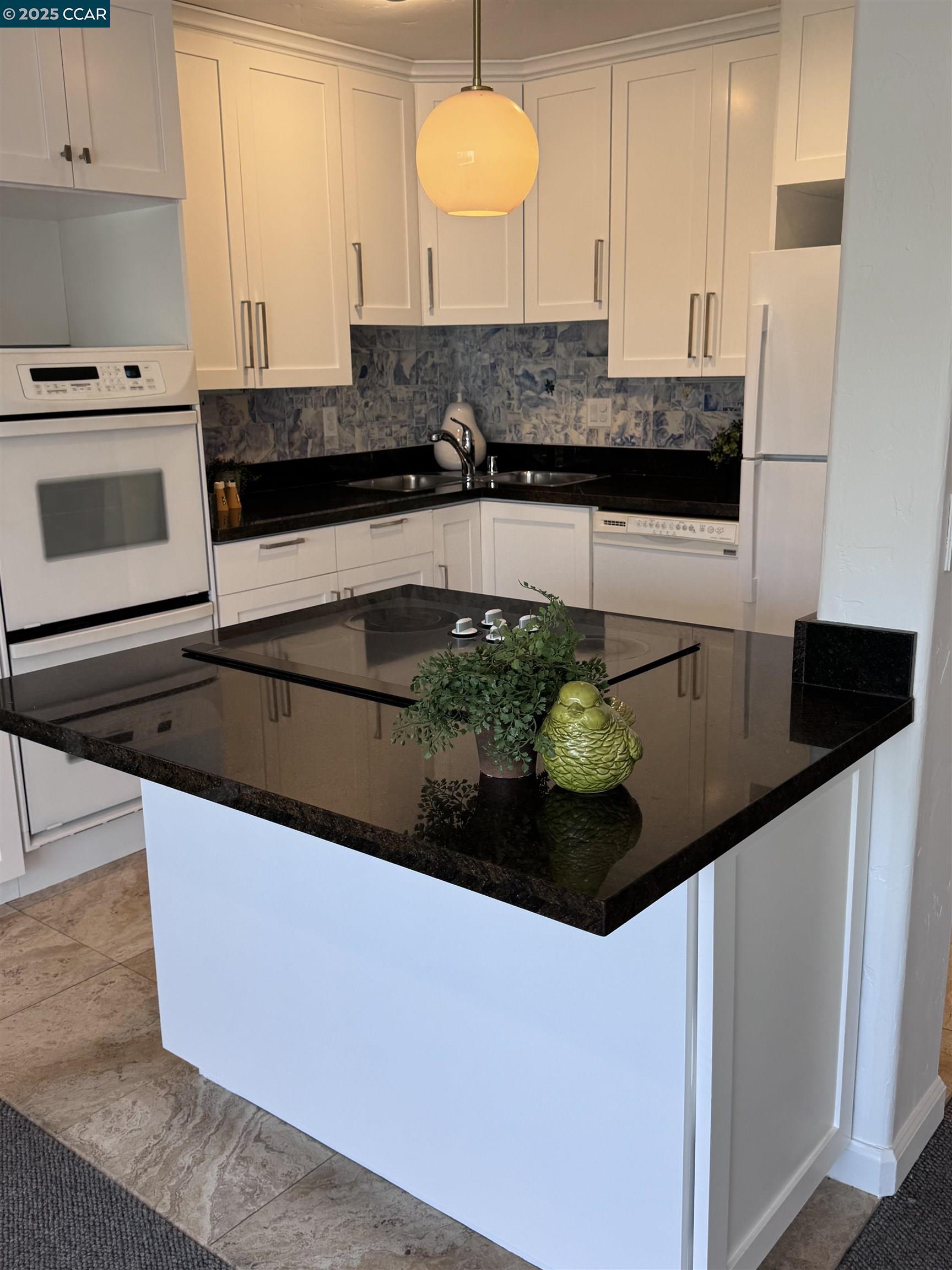 a kitchen with stainless steel appliances granite countertop a sink and a stove