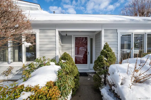 a front view of a house with outdoor seating and plants