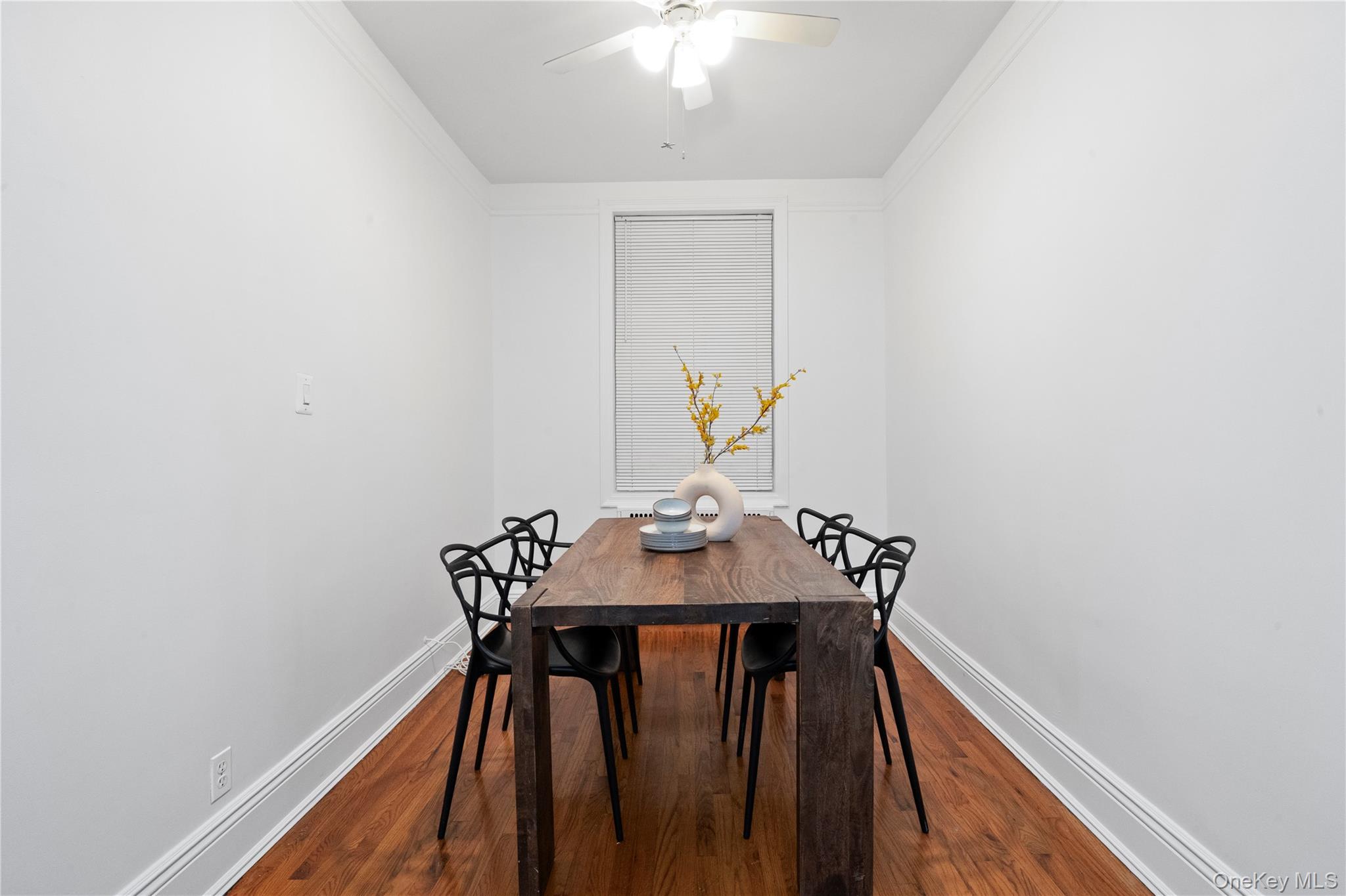 110-21 73rd Road, Unit 5H Queens, NY 11375 - Photo 6 of 14 Dining area with dark wood-style floors, ornamental molding, and ceiling fan