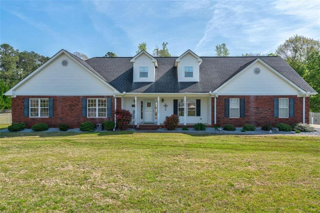 1391 West Main Street Rutledge, GA 30663 - Photo 1 of 1 a view of a brick house with a big yard and large trees