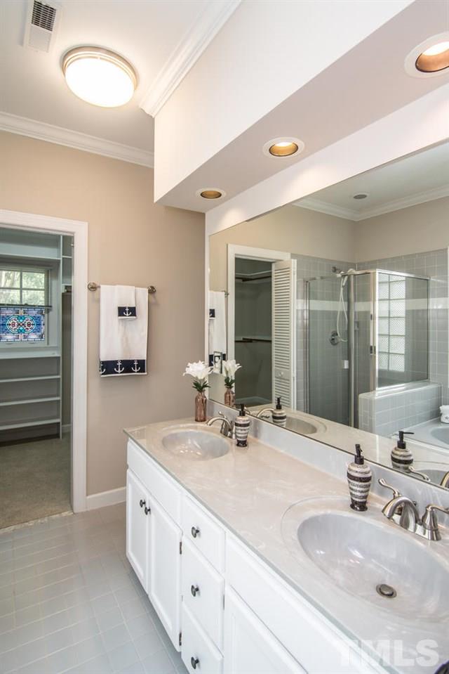 2001 Longwood Drive Raleigh, NC 27612 - Photo 20 of 25 a bathroom with double vanity sinks and a mirror