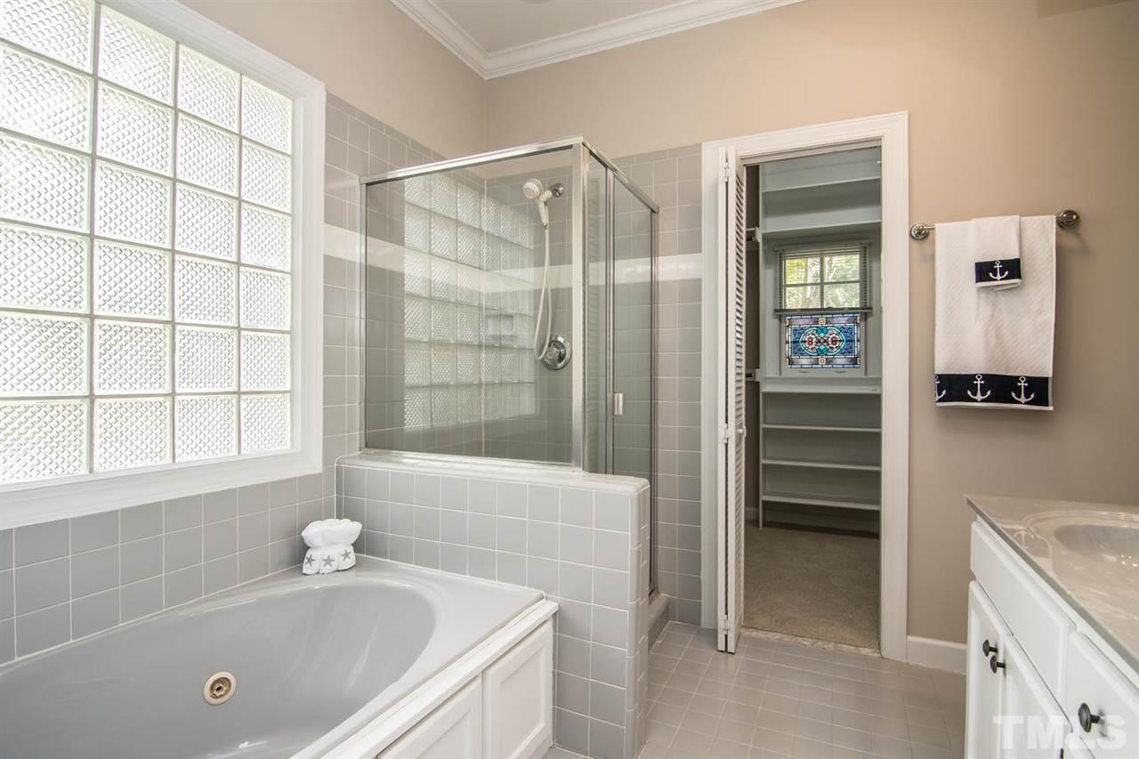 2001 Longwood Drive Raleigh, NC 27612 - Photo 21 of 25 a bathroom with a tub a sink and a shower