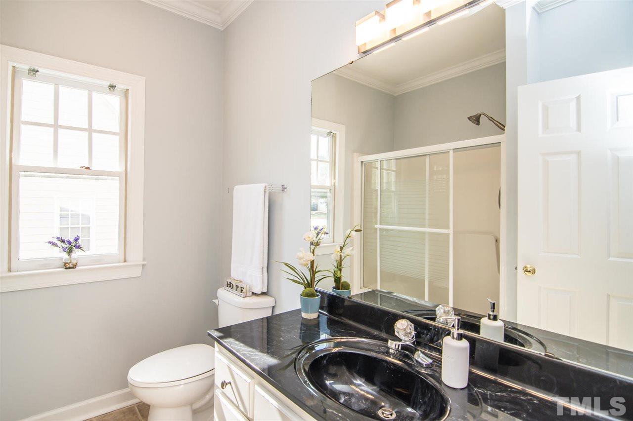 2001 Longwood Drive Raleigh, NC 27612 - Photo 24 of 25 a bathroom with a sink a toilet and a window