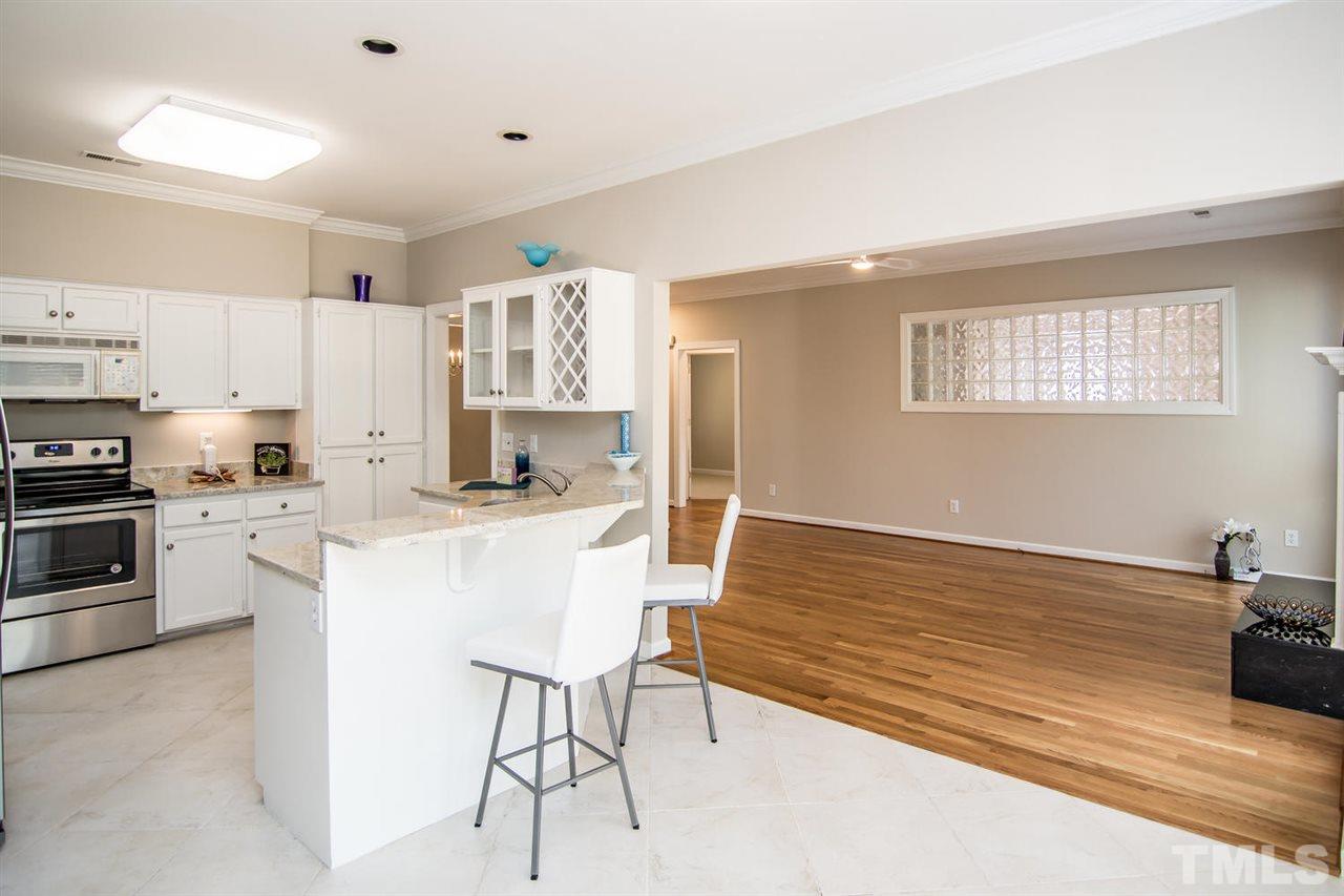 2001 Longwood Drive Raleigh, NC 27612 - Photo 5 of 25 a kitchen with stainless steel appliances kitchen island granite countertop a sink and cabinets