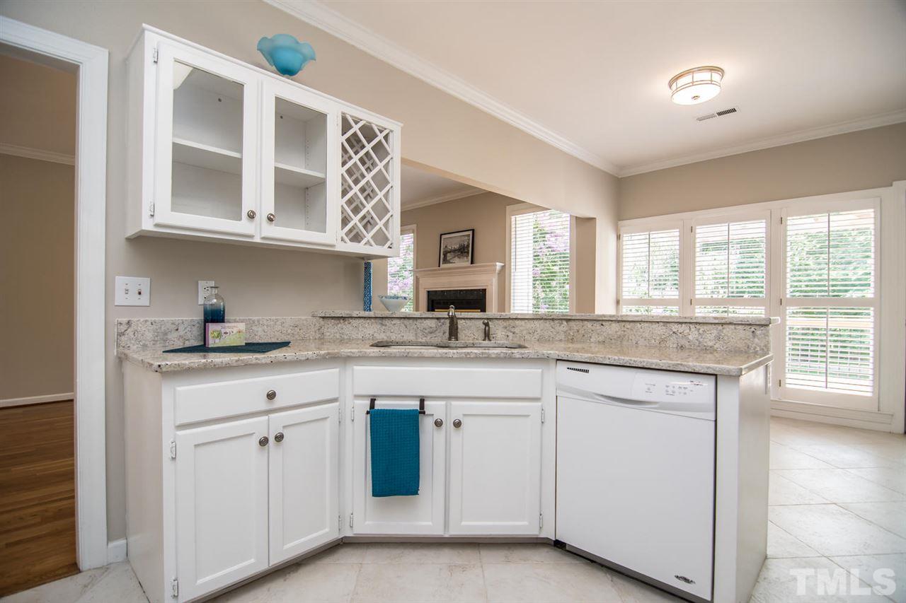 2001 Longwood Drive Raleigh, NC 27612 - Photo 10 of 25 a kitchen with granite countertop white cabinets and a sink