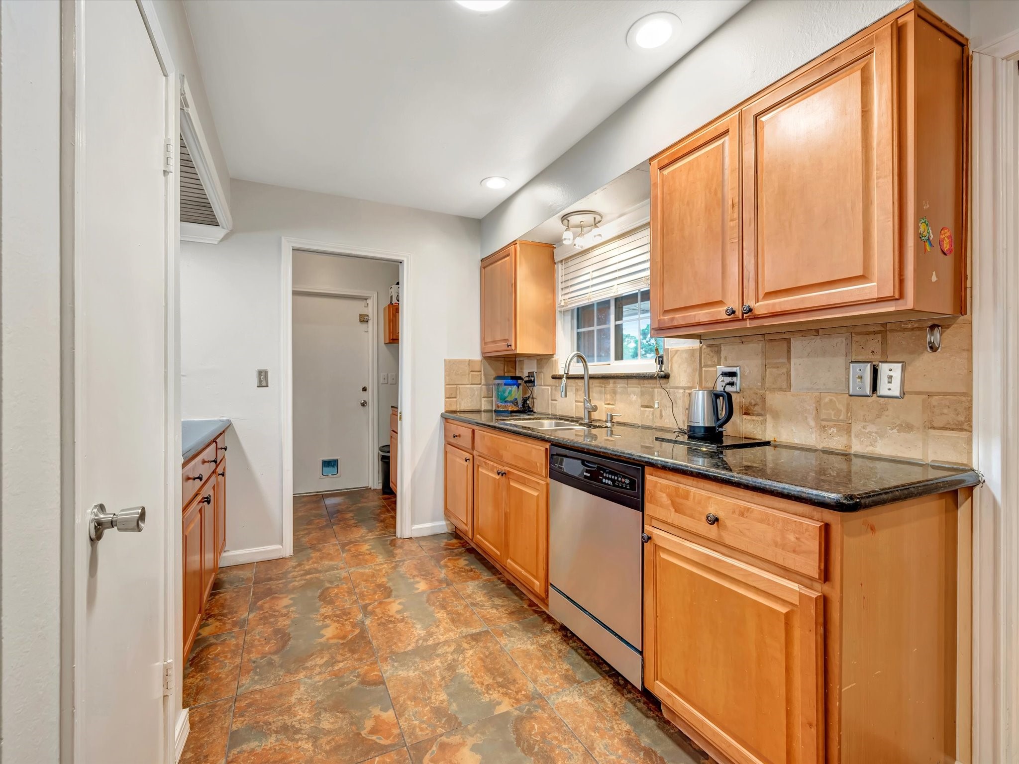 1615 Redway Lane Houston, TX 77062 - Photo 12 of 32 Nice updated kitchen with granite counter tops, stone back splash, updated cabinets and stainless appliances