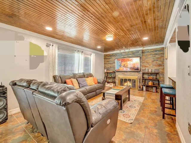 a living room with furniture a rug and a chandelier