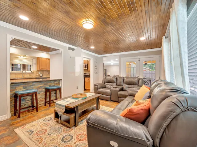 a room with kitchen island a table and chairs