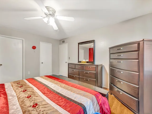 a bedroom with a bed and a chandelier