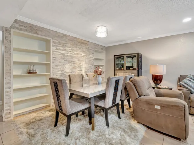 a living room with furniture and a piano