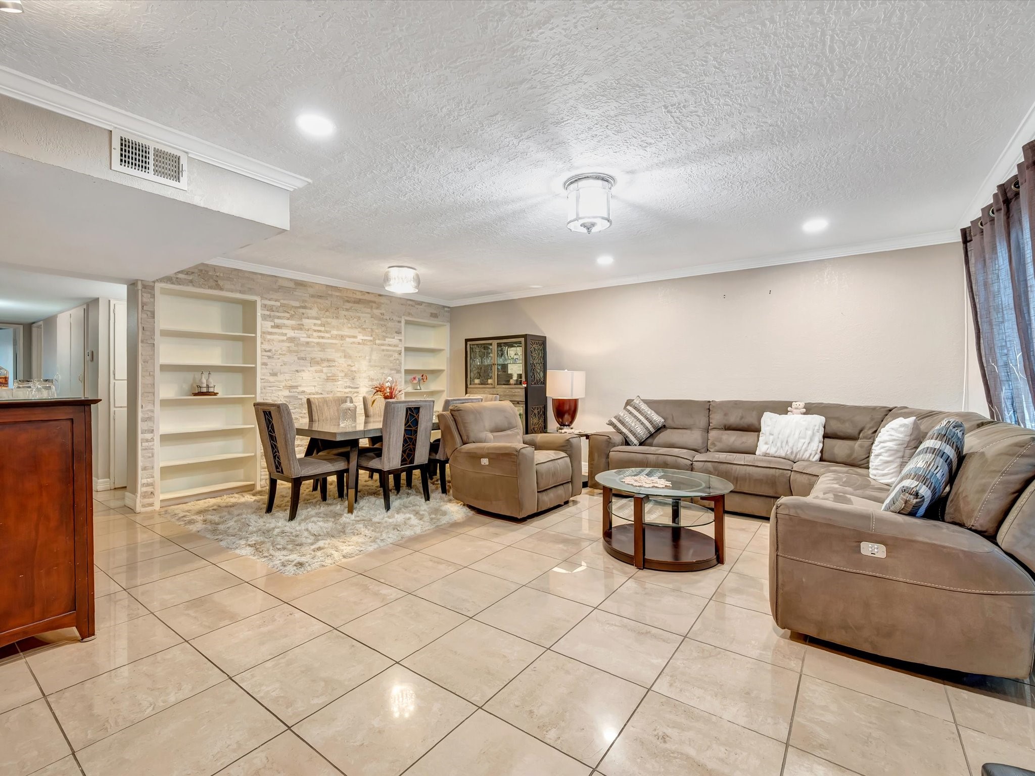 1615 Redway Lane Houston, TX 77062 - Photo 10 of 32 This living/ dining room has fantastic stacked-stone accent wall along with tile floors and built-in book shelves