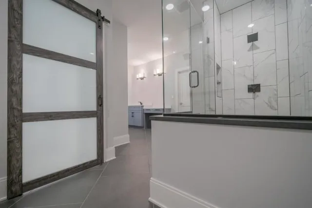 a bathroom with a shower and a mirror