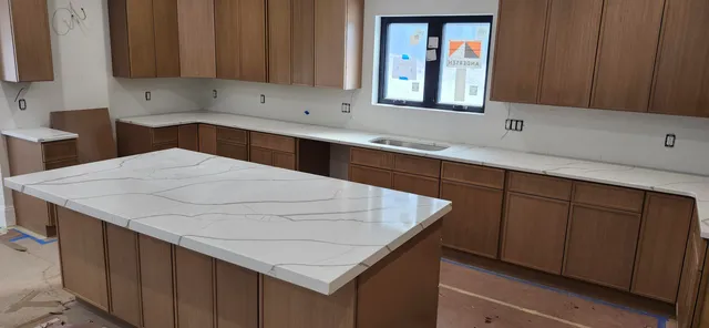 a kitchen with a sink cabinets and window