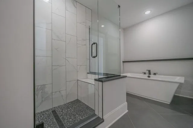 a bathroom with a granite countertop sink a toilet a mirror and shower