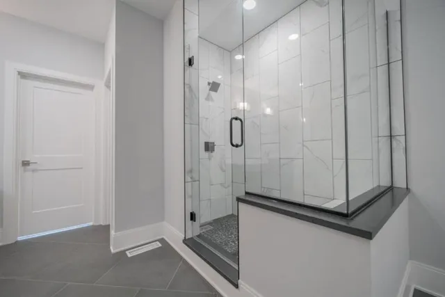 a bathroom with a shower and a sink
