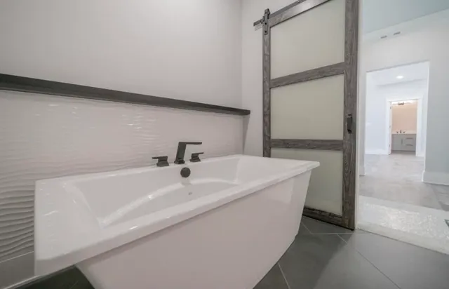 a bathroom with a bathtub and a sink