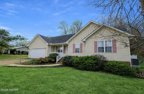a view of a house with a yard and garage