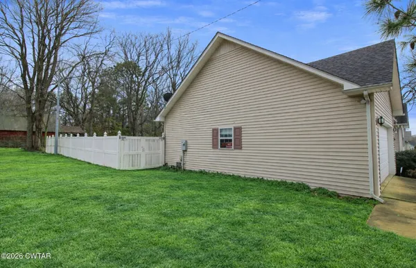 a view of a park with large trees