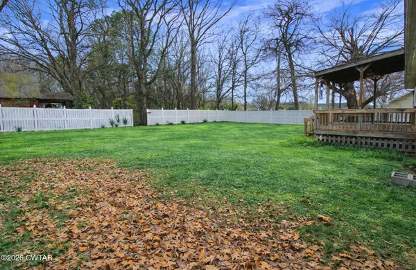 a view of a backyard with large trees