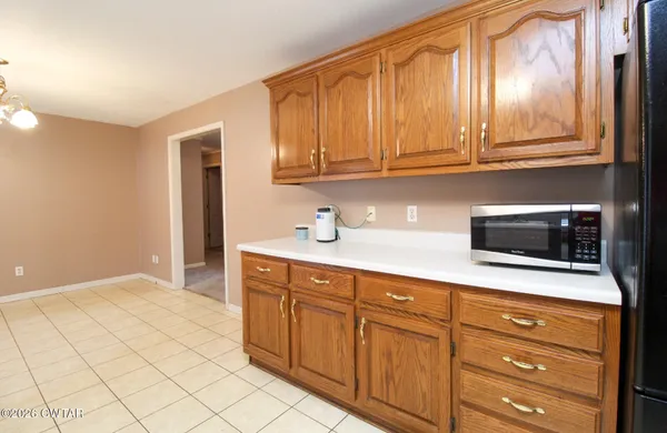 a kitchen with stainless steel appliances granite countertop a refrigerator and a microwave