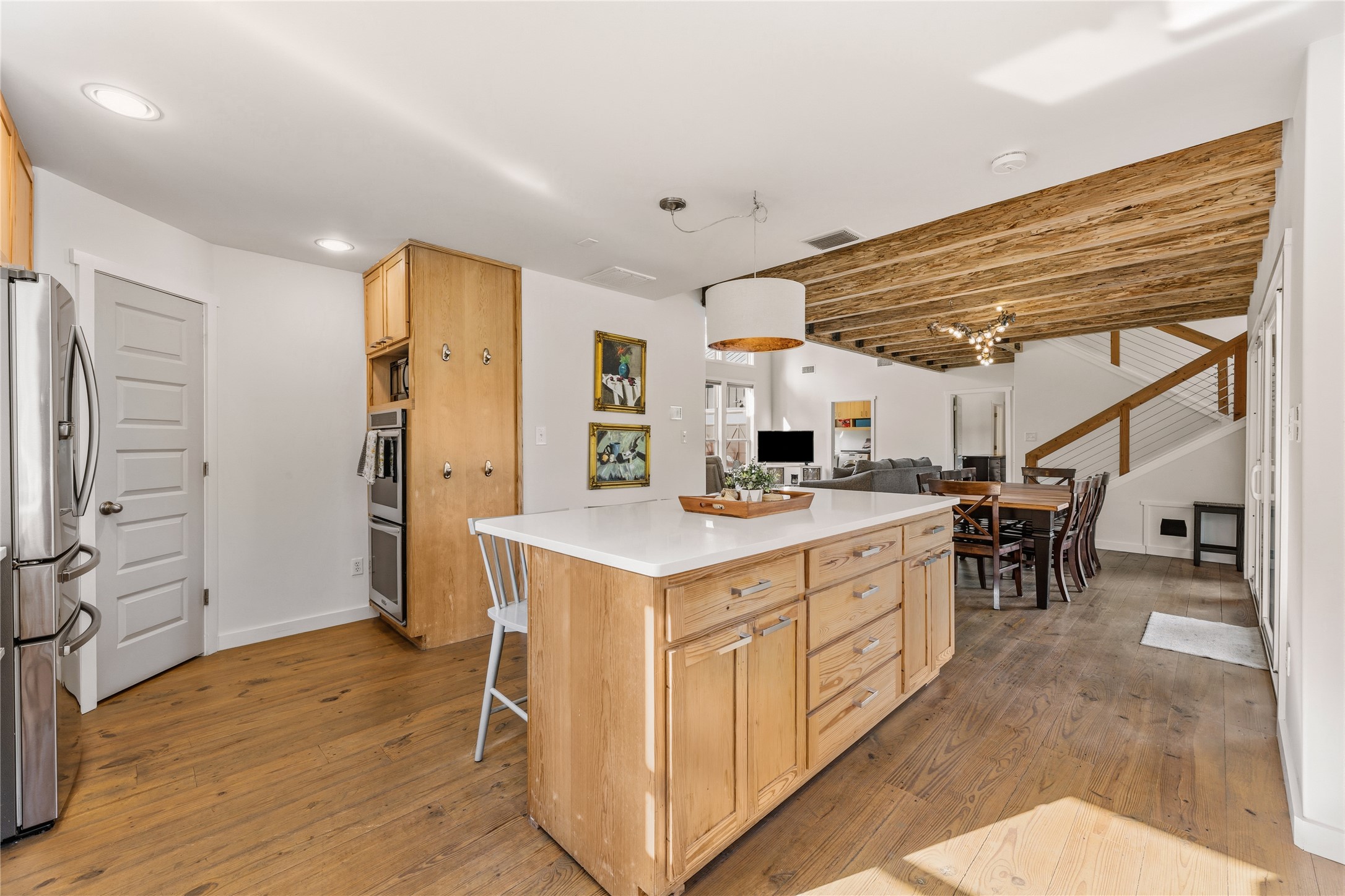 12901 Wire Road Leander, TX 78641 - Photo 6 of 40 Rich wood floors and dynamic beamed ceilings anchor this open concept kitchen design.
