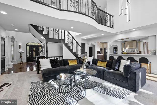a living room with furniture large window and flat screen tv
