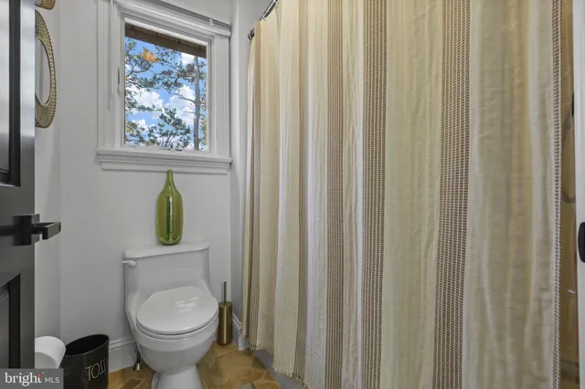 a living room with furniture a rug and a flat screen tv