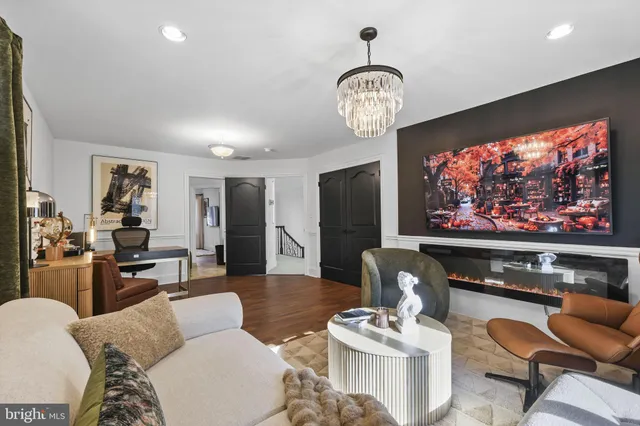 a bedroom with furniture and a large window