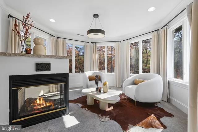 a bathroom with a tub a sink and a large mirror