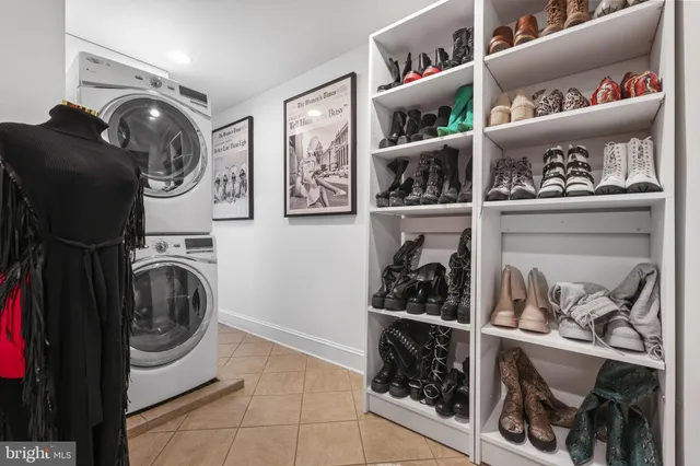 a bedroom with a bed chandelier and a window