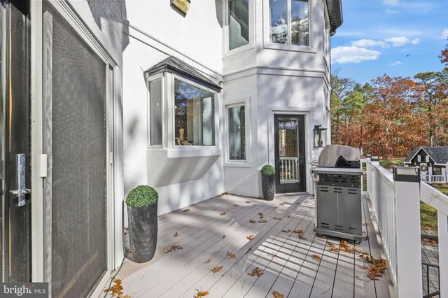 a front view of a house with a yard covered with snow