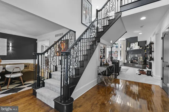 a view of entryway livingroom and hall with wooden floor
