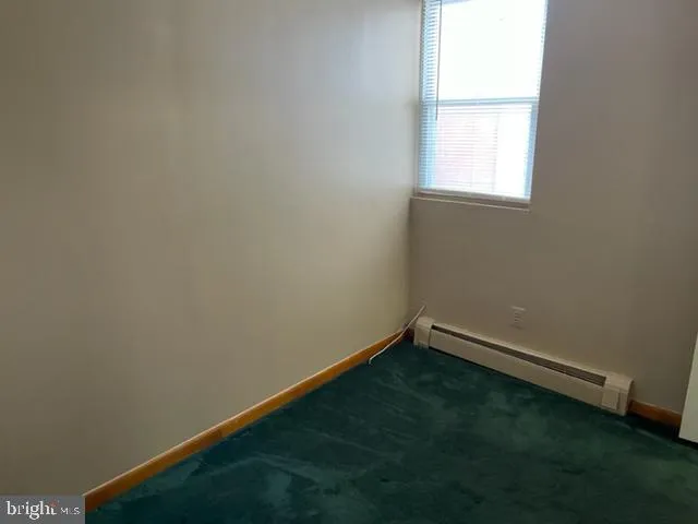 a white toilet sitting next to a white sink