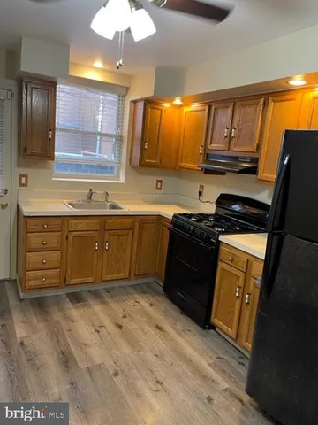 a kitchen with stainless steel appliances granite countertop a sink and cabinets
