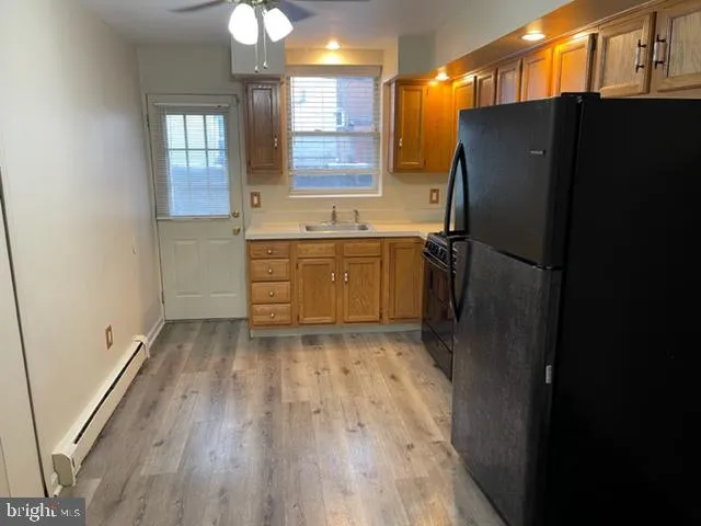 a kitchen with stainless steel appliances a refrigerator and a sink