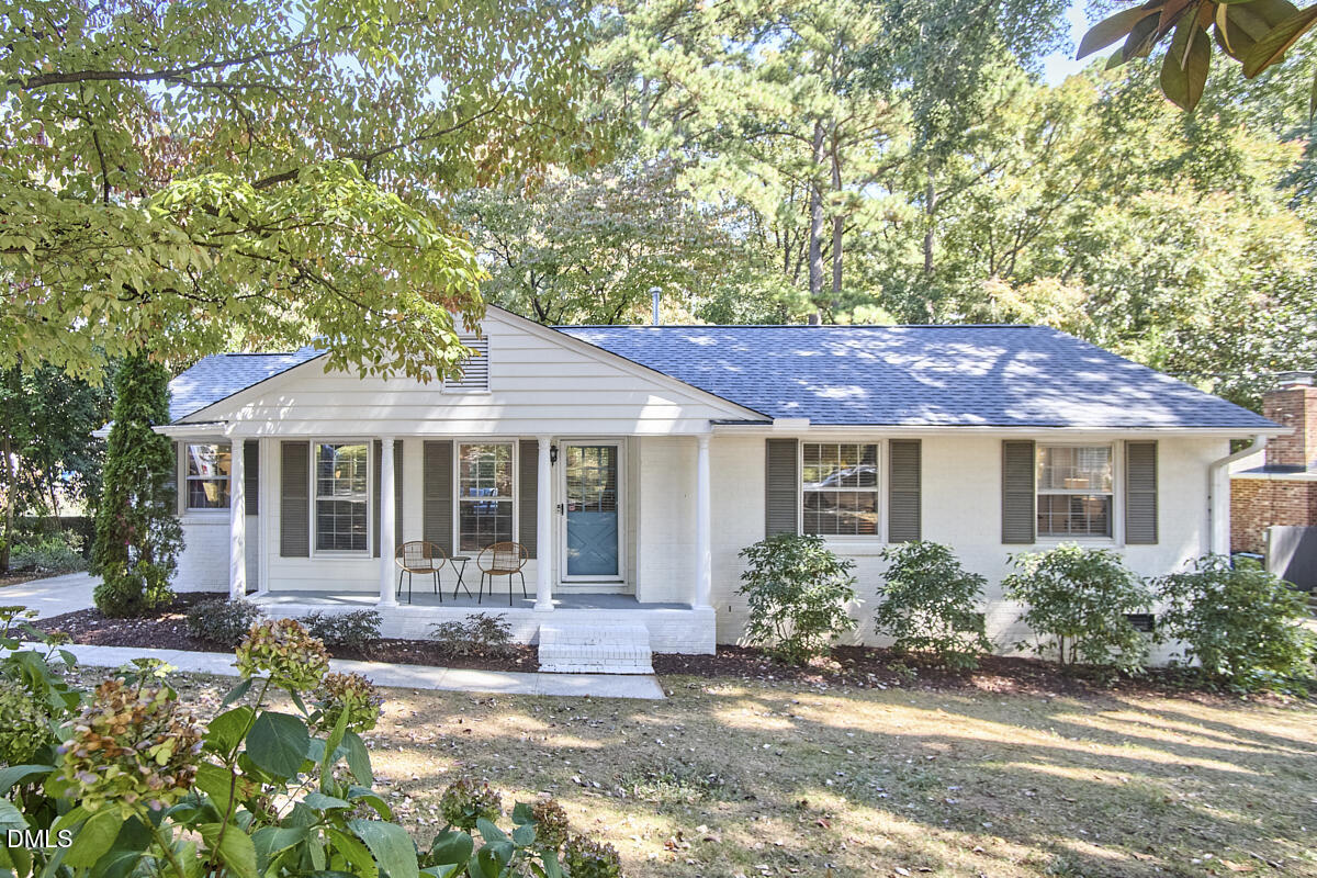 4916 Latimer Road Raleigh, NC 27609 - Photo 1 of 30 a front view of a house with a garden