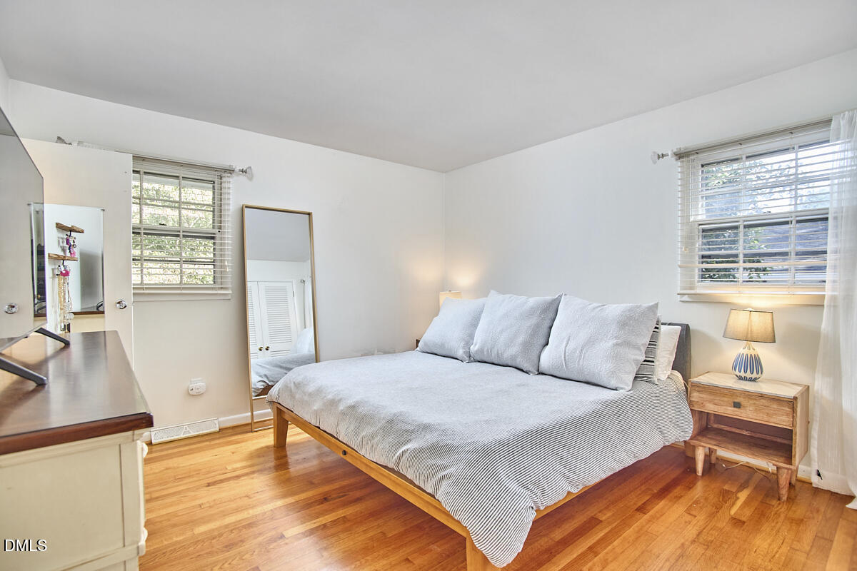 4916 Latimer Road Raleigh, NC 27609 - Photo 17 of 30 a bedroom with a large bed and a flat tv screen on dresser