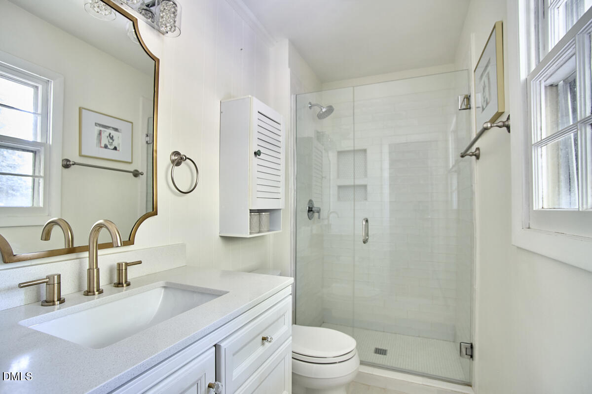 4916 Latimer Road Raleigh, NC 27609 - Photo 18 of 30 a bathroom with a sink a toilet and shower