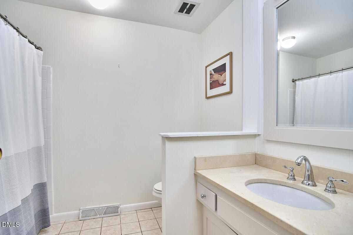 4916 Latimer Road Raleigh, NC 27609 - Photo 22 of 30 a bathroom with a sink toilet and vanity