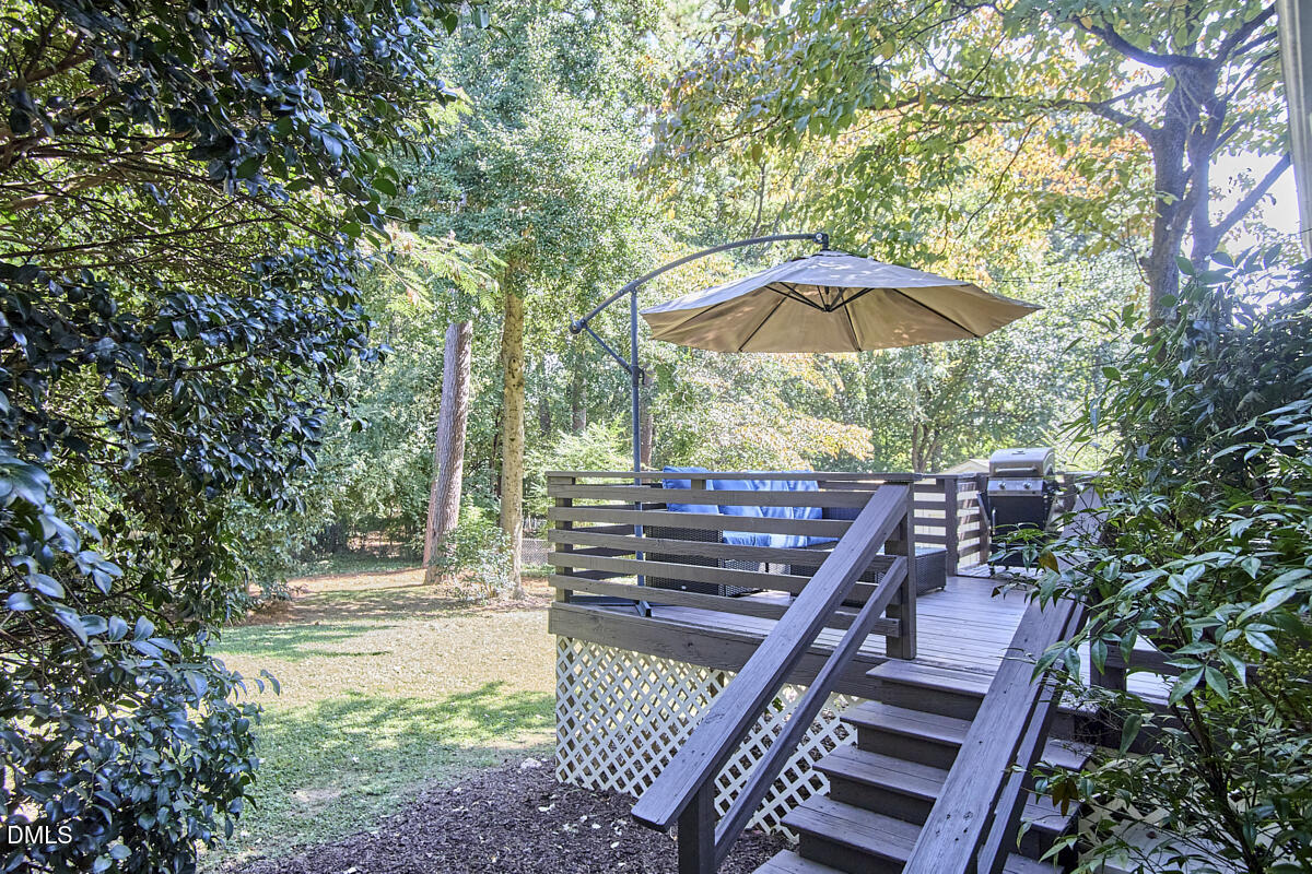 4916 Latimer Road Raleigh, NC 27609 - Photo 26 of 30 a view of a patio with chairs under an umbrella
