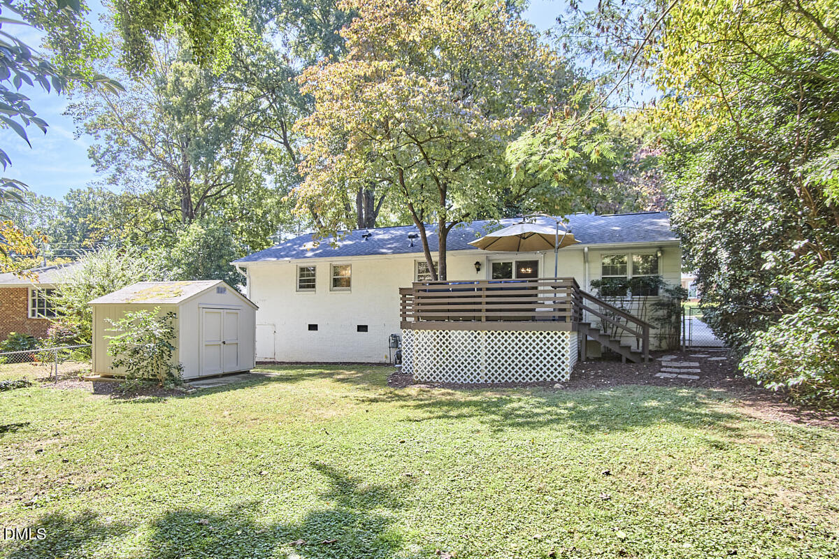 4916 Latimer Road Raleigh, NC 27609 - Photo 29 of 30 a front view of a house with a yard and a garage