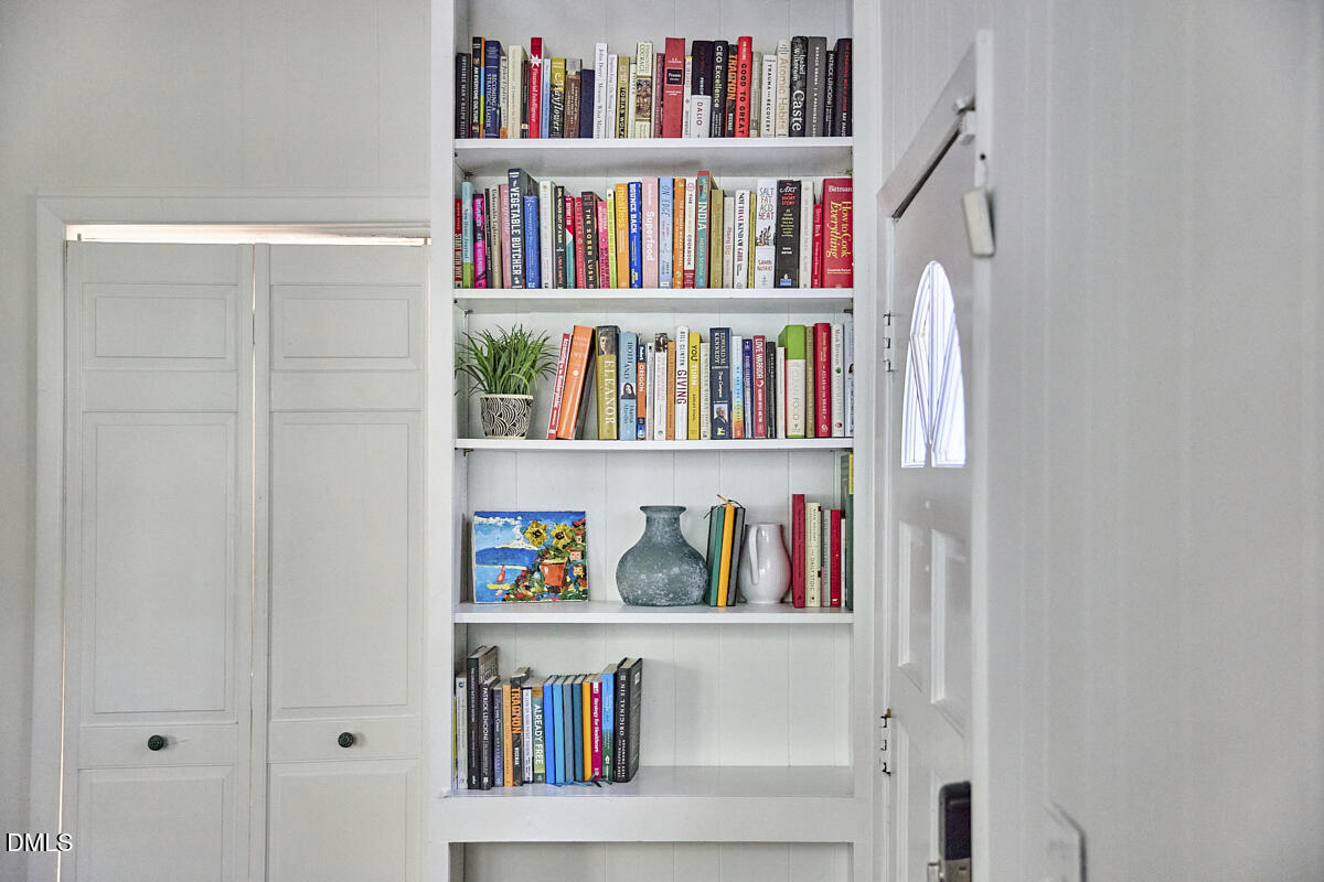 4916 Latimer Road Raleigh, NC 27609 - Photo 4 of 30 a book shelf with books on the shelf