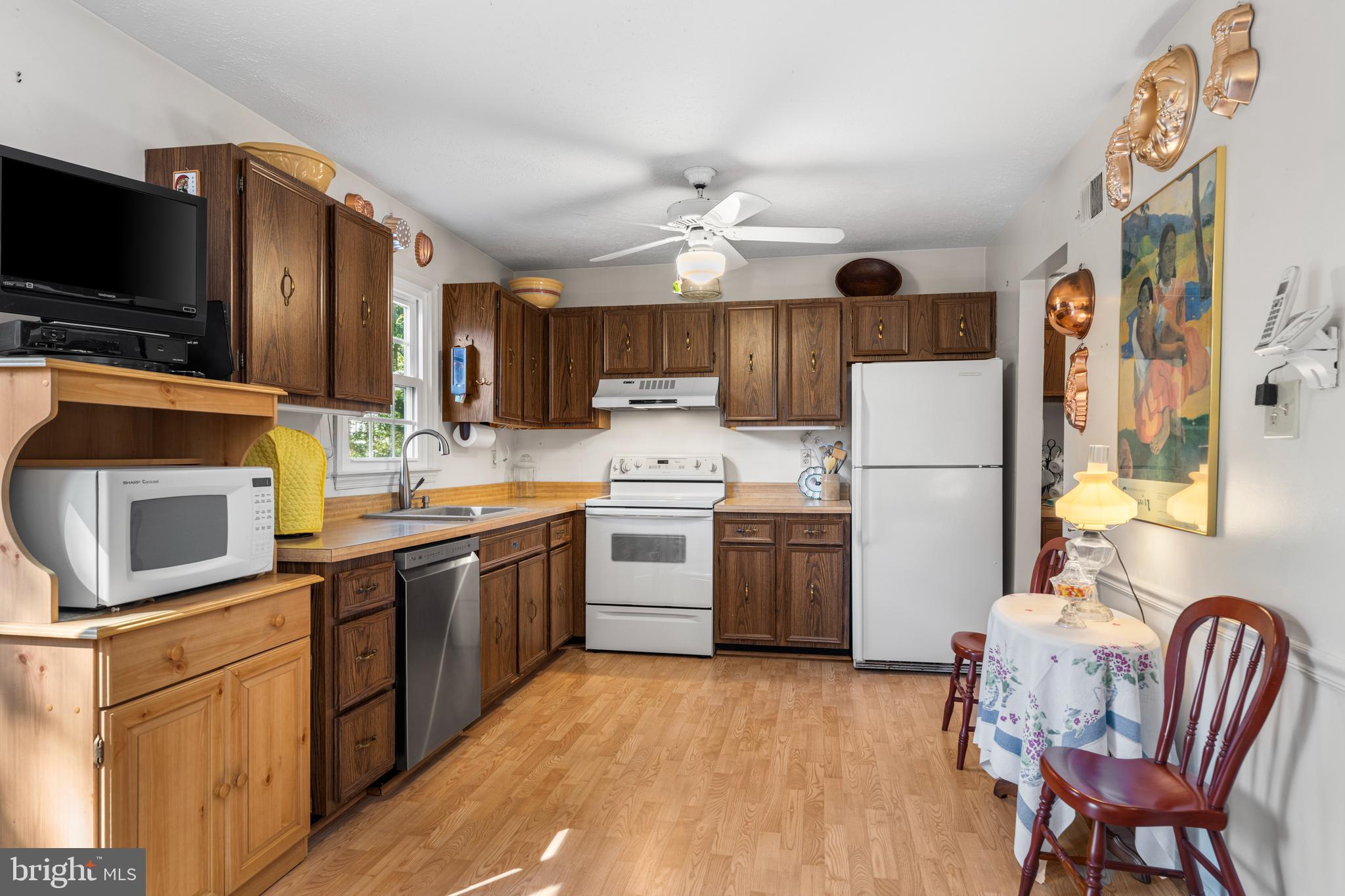 2110 Sandy Court Crofton, MD 21114 - Photo 11 of 50 a kitchen with a microwave a stove a sink dishwasher a refrigerator and a microwave oven with a dining table
